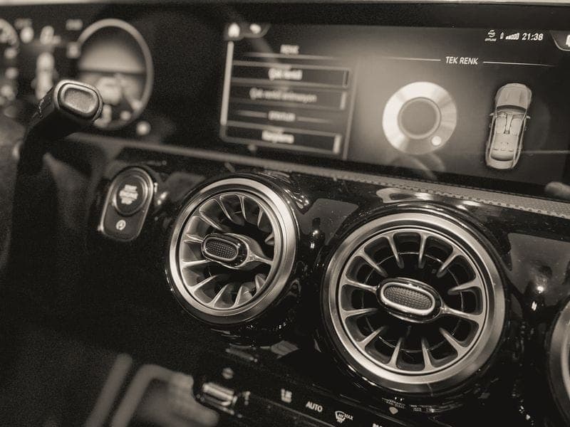 A car's dashboard air-conditioning vents and controls