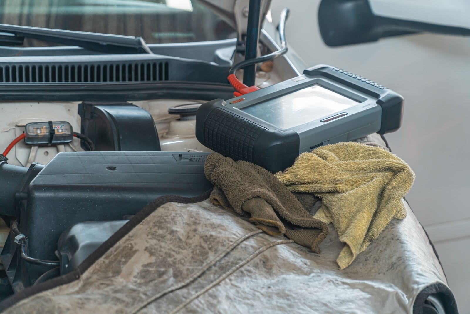 A vehicle diagnostic tool on an engine