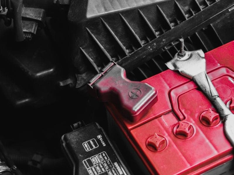 A car battery in the engine bay