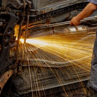 Sparks flying while grinding a vehicle's metal underbody