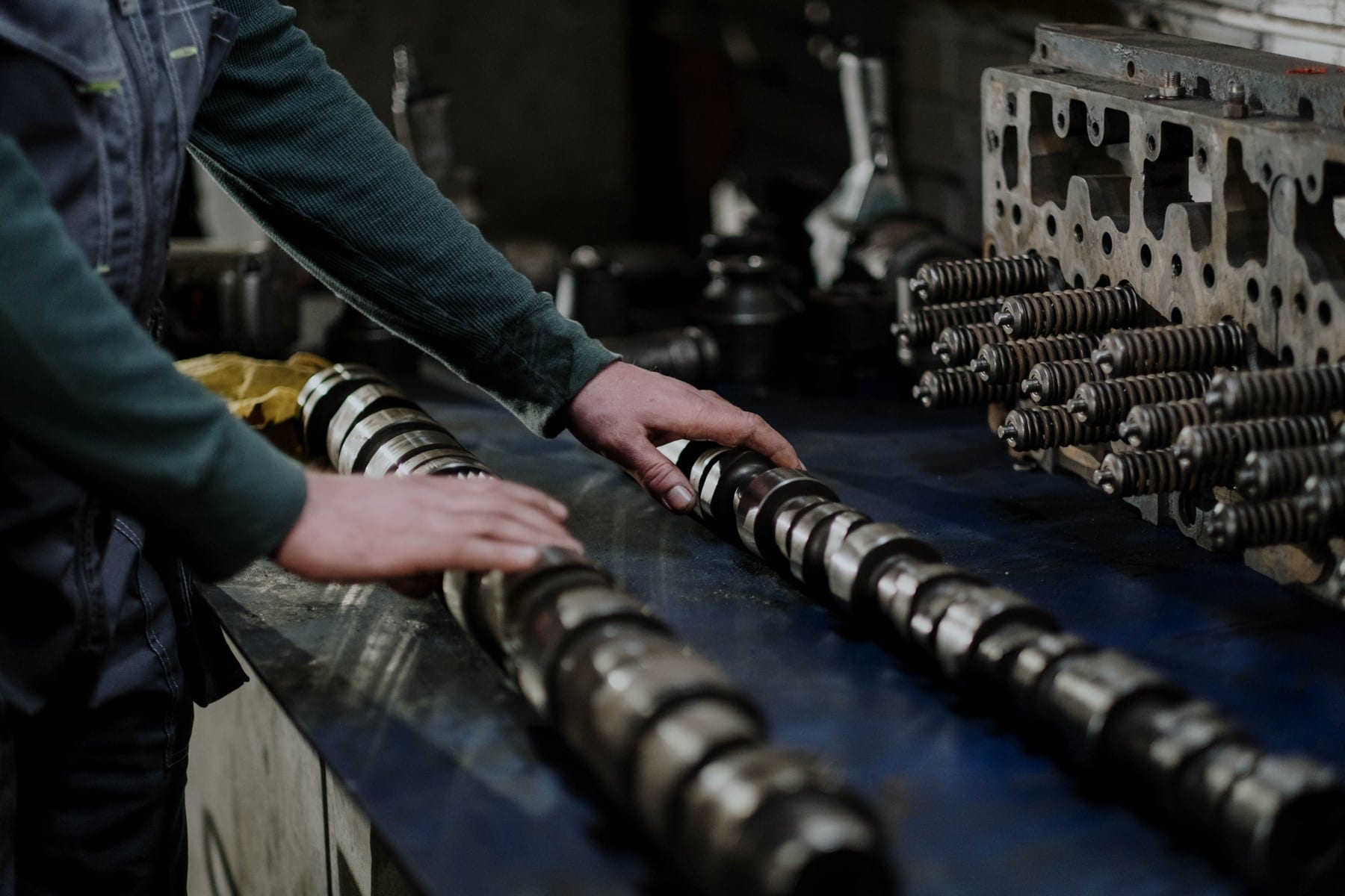 A technician performing detailed engine work