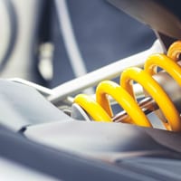 Close-up of a car's coilover spring and shock absorber
